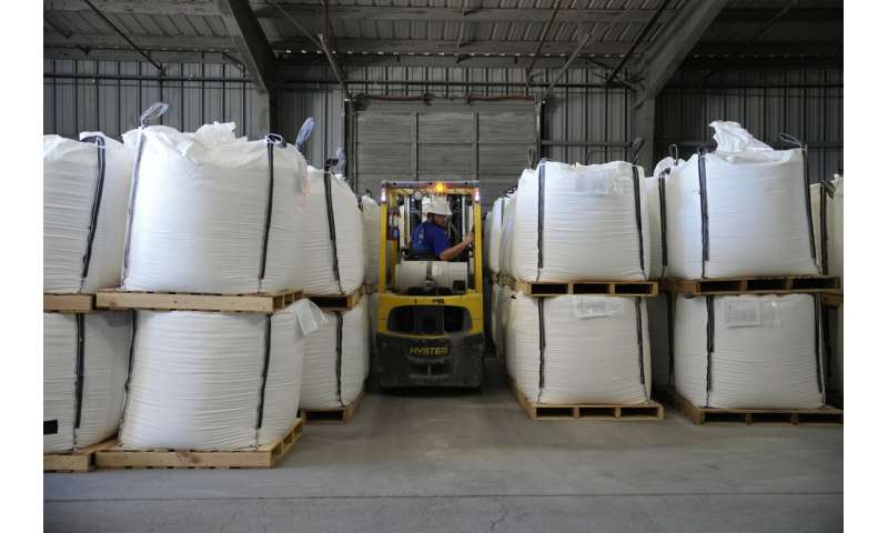 Threatened by shortages, electric car makers race for supplies of lithium for batteries