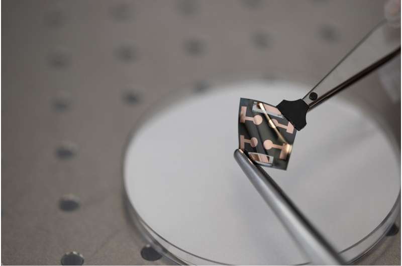 A perovskite solar cell is examined using laboratory equipment. Credit: The University of Sydney Houston, we have a solution