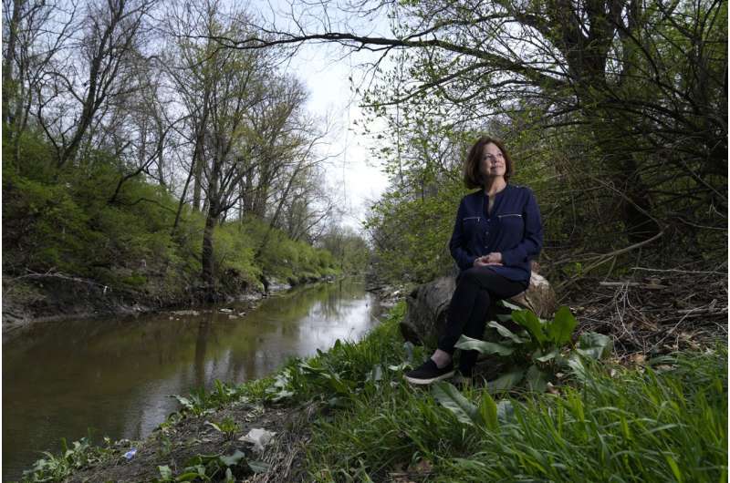 Susie Gaffney poses for a photo along Coldwater Creek near where she used to live Friday, April 7, 2023, in Florissant, Mo. The creek was contaminated when nuclear waste from the Manhattan Project flowed into the waterway past homes, schools and businesses. St. Louis played an important role in the country’s effort to build the first nuclear weapon. Credit: AP Photo/Jeff Roberson How America’s push for the atomic bomb spawned enduring radioactive waste problems in St. Louis