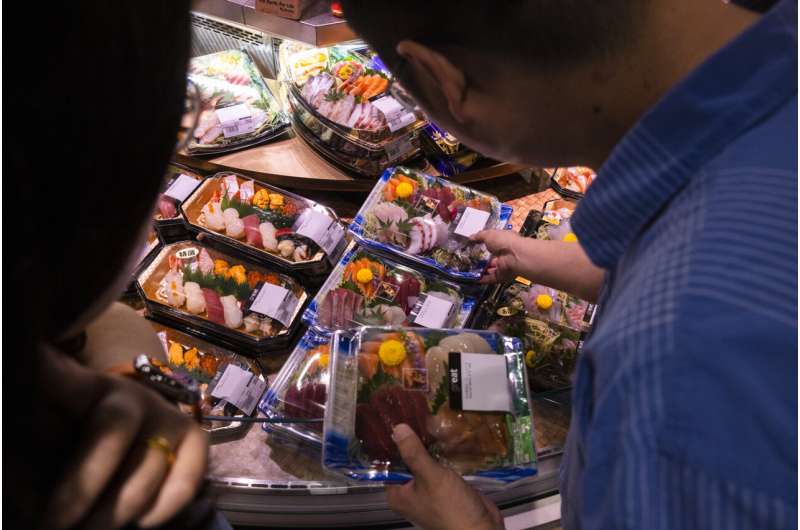 Customers browse Japanese imported sea products in Hong Kong, Wednesday, July 12, 2023. Hong Kong would immediately ban the import of aquatic products from Fukushima and other Japanese prefectures if Tokyo discharges treated radioactive wastewater into the sea, a top official in the city said Wednesday. Credit: AP Photo/Louise Delmotte Ripples of Fukushima: Hong Kong will ban more Japanese products if radioactive water is released