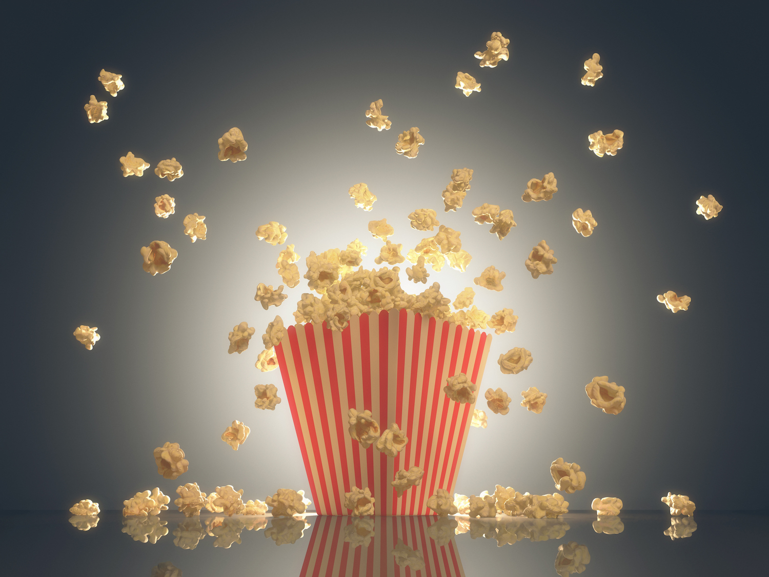 Popcorn exploding out of the striped package. Clipping path included.