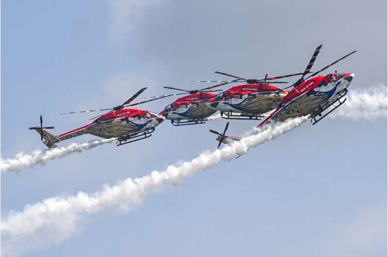 Members of the Sarang Helicopter Display Team of the Indian Air Force (IAF) perform with modified HAL Dhruv helicopters, also known as Advanced Light Helicopter (ALH), during a preview of the Singapore Airshow in Singapore on February 18, 2024. Members of the Sarang Helicopter Display Team of the Indian Air Force (IAF) perform with modified HAL Dhruv helicopters, also known as Advanced Light Helicopter (ALH), during a preview of the Singapore Airshow in Singapore on February 18, 2024