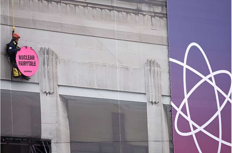 A Greenpeace activist at the nuclear summit venue with a banner reading 'Nuclear Fairy Tale'