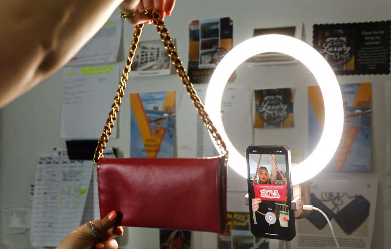 A luxury handbag is displayed by Samantha Mayer, Deborah Mayer's daughter, on TikTok., Wednesday, March 21, 2024, in Freehold, N.J. Deborah Mayer has sold new and pre-owned handbags and other designer goods out of her home for 16 years. Early last year, TikTok recruited her business for the live component of TikTok Shop. Credit: AP Photo/Noah K. Murray Big brands could pivot easily if TikTok goes away. For many small businesses, it's another story
