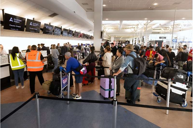 Passengers stand in a line at the LATAM Airlines check-in counters at Auckland International Airport in Auckland on March 12, a day after a Boeing-made LATAM plane bound for New Zealand suddenly lost altitude mid-flight. Passengers stand in a line at the LATAM Airlines check-in counters at Auckland International Airport in Auckland on March 12, a day after a Boeing-made LATAM plane bound for New Zealand suddenly lost altitude mid-flight